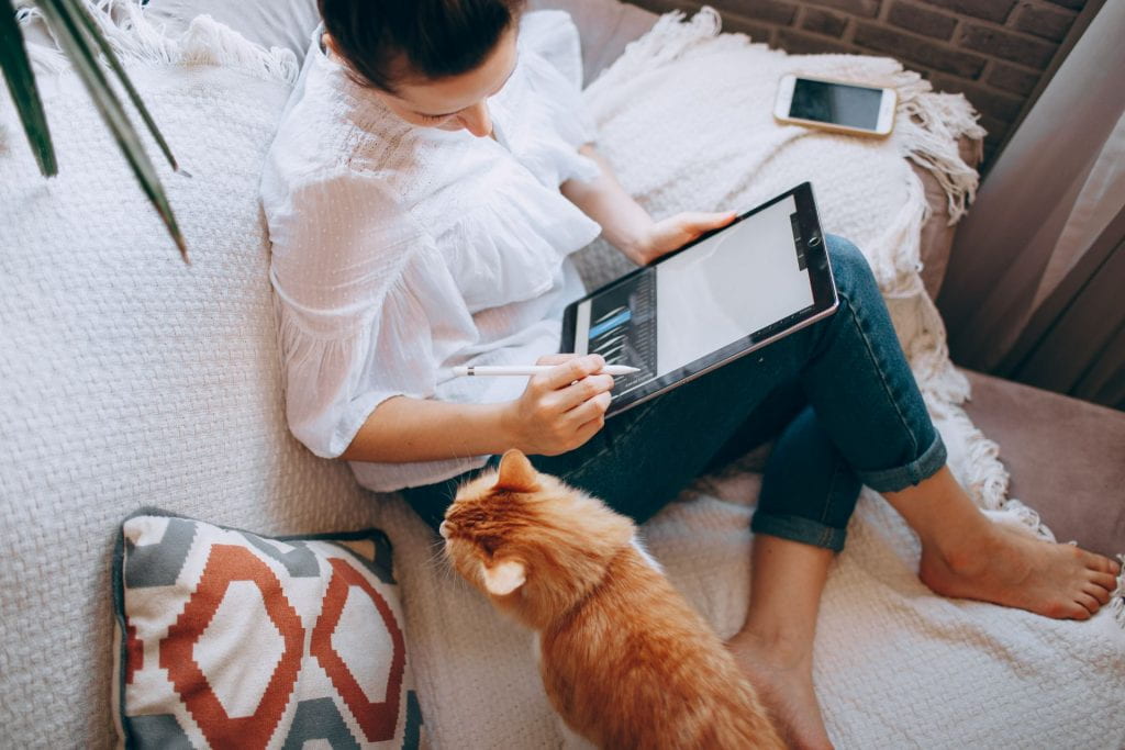 woman working at home with cat