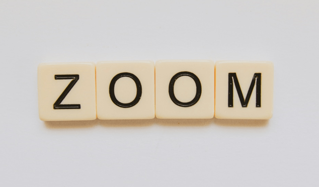 Scrabble pieces that spell out the word Zoom.